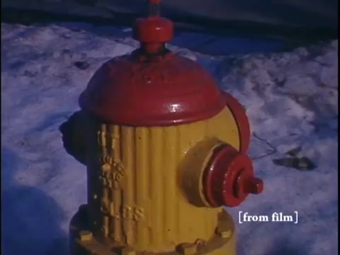 Close-up of a vibrant yellow fire hydrant set against a snowy street.